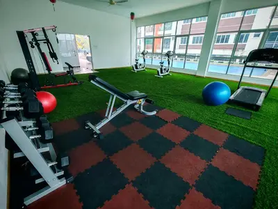 a room with a gym with exercise equipment and grass at Pavilionvillie M1T695 by irainbow in Ipoh