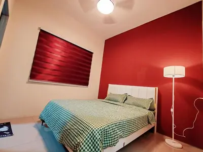 a bedroom with a bed with a red wall at Pavilionvillie M1T695 by irainbow in Ipoh