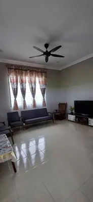 a living room with a couch and a ceiling fan at teratai ciknah in Penaga