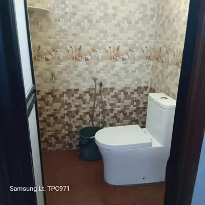 a bathroom with a white toilet in a room at teratai ciknah in Penaga