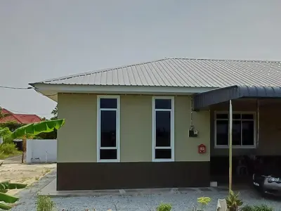 a small green house with a metal roof at teratai ciknah in Penaga