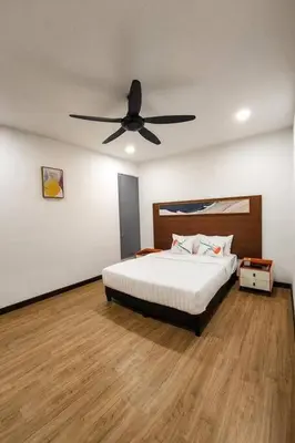 a bedroom with a bed and a ceiling fan at Zinnia Residence in Tanah Rata