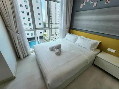 a large bed in a room with a large window at Modern Suite in Penang Island in Jelutong