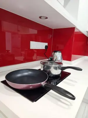 a pan sitting on top of a stove in a kitchen at Modern Suite in Penang Island in Jelutong