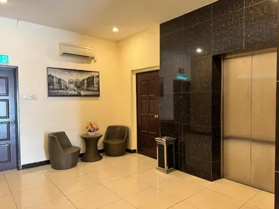 a waiting room with two chairs and a shower at K Garden Hotel (BS) in Bagan Serai