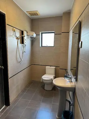 a bathroom with a toilet and a sink at K Garden Hotel (BS) in Bagan Serai