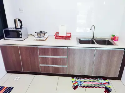 a kitchen counter with a sink and a microwave at Kinta Riverfront Apartment, Jalan Lim Bo Seng Ipoh in Ipoh
