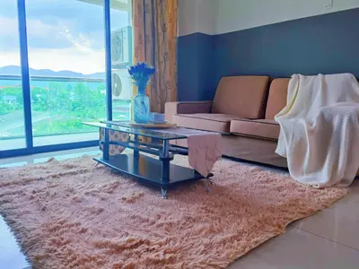 a living room with a couch and a table at Kinta Riverfront Apartment, Jalan Lim Bo Seng Ipoh in Ipoh