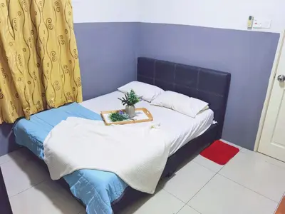 a small bed with a tray with a plant on it at Kinta Riverfront Apartment, Jalan Lim Bo Seng Ipoh in Ipoh