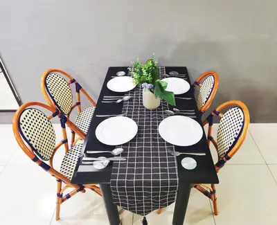 a black table with chairs and a plant on it at Kinta Riverfront Apartment, Jalan Lim Bo Seng Ipoh in Ipoh