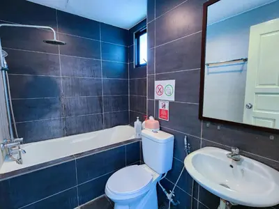 a bathroom with a toilet and a sink and a mirror at Kinta Riverfront Apartment, Jalan Lim Bo Seng Ipoh in Ipoh