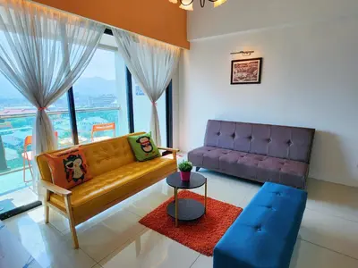 a living room with a couch and a table at Kinta Riverfront Apartment, Jalan Lim Bo Seng Ipoh in Ipoh