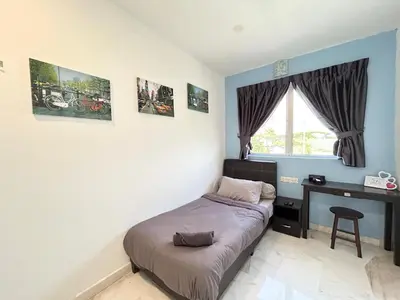 a bedroom with a bed and a desk and a window at Comfortable Homestay Ipoh 6R6B 9pax SY30 in Ipoh