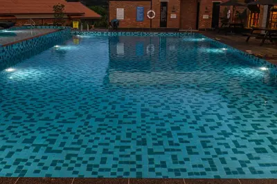 a large swimming pool with lights in it at Sebayu Retreat Gopeng in Gopeng