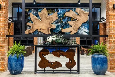 two blue vases and two wooden cutouts on a table at Sebayu Retreat Gopeng in Gopeng