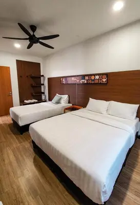 a bedroom with two beds and a ceiling fan at ZINNIA RESIDENCE in Tanah Rata