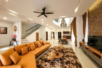 a living room with a couch and a ceiling fan at ZINNIA RESIDENCE in Tanah Rata