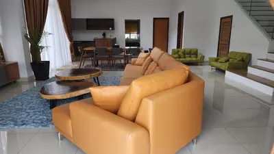 a living room with a couch and a table at ZINNIA RESIDENCE in Tanah Rata