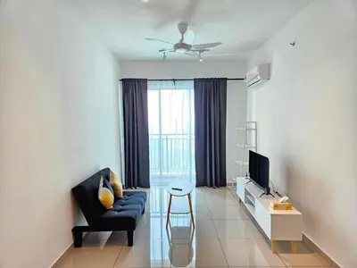 a living room with a blue couch and a television at Metropol Serviced Apartment Bukit Mertajam Perda in Bukit Mertajam