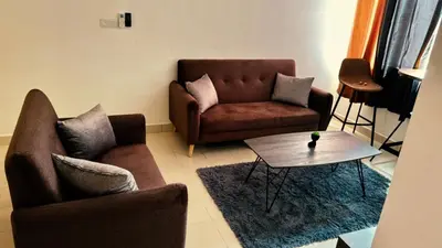 a living room with a couch and a table at Prima Falim in Ipoh