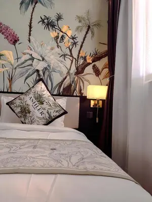 a bedroom with a bed with a floral wallpaper at The Palm Suite Tanjung Tokong in George Town