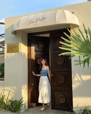 a woman standing in the doorway of a building at The Palm Suite Tanjung Tokong in George Town