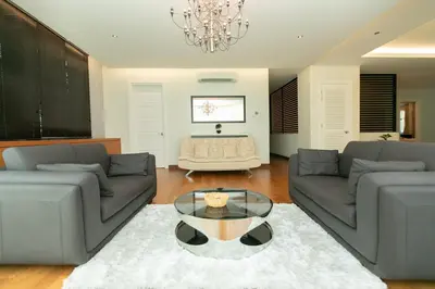 a living room with two couches and a glass table at Tanjung Bungah 5BR 18 Bungalow KTV in Tanjung Bungah