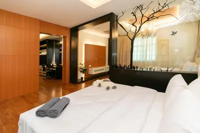 a bedroom with a bed with two towels on it at Tanjung Bungah 5BR 18 Bungalow KTV in Tanjung Bungah