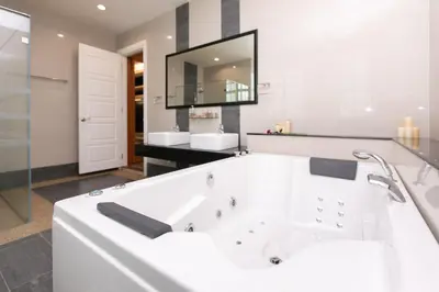 a white bathroom with a tub and a mirror at Tanjung Bungah 5BR 18 Bungalow KTV in Tanjung Bungah