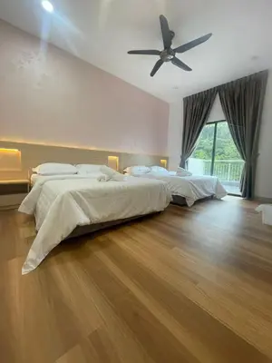 a bedroom with two beds and a ceiling fan at Adik aisyah teres golden hill Cameron Highlands in Brinchang