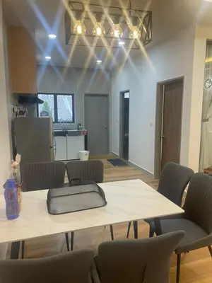 a room with a table with chairs and a kitchen at Adik aisyah teres golden hill Cameron Highlands in Brinchang