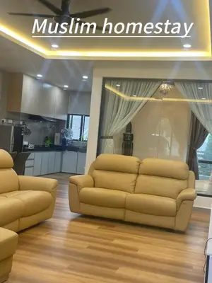 a living room with two couches and a kitchen at Adik aisyah teres golden hill Cameron Highlands in Brinchang