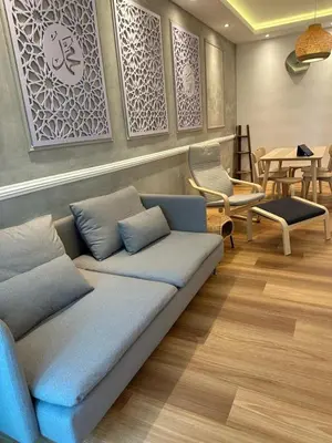a living room with a blue couch and chairs at Adik Aisyah Muji Homestay Cameron Highlands N in Cameron Highlands