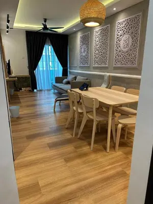 a dining room with a table and chairs and a couch at Adik Aisyah Muji Homestay Cameron Highlands N in Cameron Highlands