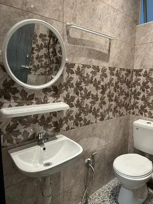a bathroom with a sink and a mirror and a toilet at Adik Aisyah Muji Homestay Cameron Highlands N in Cameron Highlands