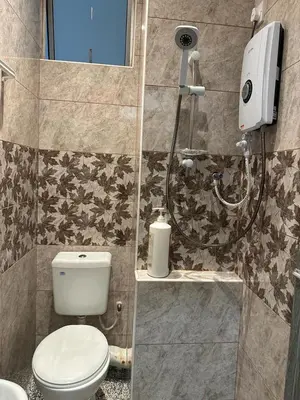 a bathroom with a toilet and a shower at Adik Aisyah Muji Homestay Cameron Highlands N in Cameron Highlands