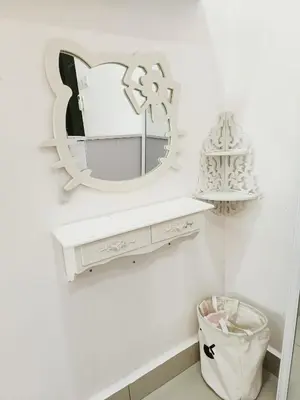 a mirror above a white vanity in a bathroom at perdana homestay in Ipoh