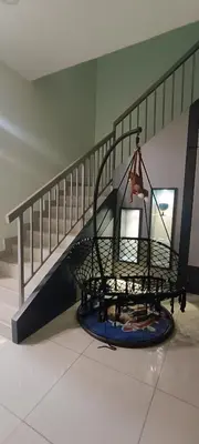 a staircase with a metal cage with a purse on it at perdana homestay in Ipoh