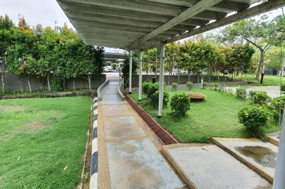a covered walkway in a park with a yard at Sky Residence -3 Bedrooms Condo at Cinta Sayang, Sungai Petani in Sungai Petani