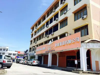 a large building with cars parked in front of it at CLP Perai Homestay Apartment in Chai Leng park in Perai