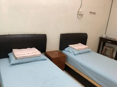 two beds sitting next to each other in a room at CLP Perai Homestay Apartment in Chai Leng park in Perai