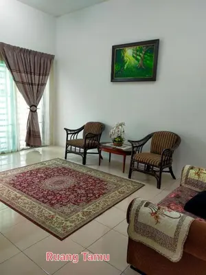 a living room with two chairs and a rug at FJ Homestay in Seri Iskandar