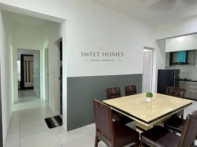 a dining room with a table and chairs and a kitchen at CozySuite3R2B#5mintoPenangBridge in Perai