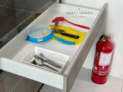 a drawer with utensils on top of a counter at CozySuite3R2B#5mintoPenangBridge in Perai