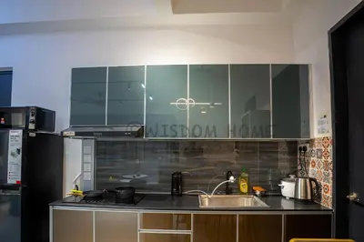 a kitchen with a sink and some glass cabinets at Seaview Urban suites Georgetown @Penang in Jelutong