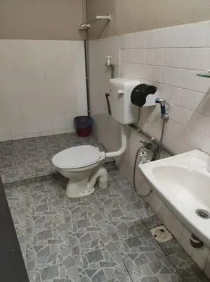 a bathroom with a toilet and a sink at HomeStay Pulai in Ipoh