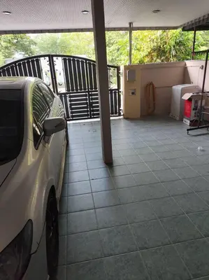 a white car parked on a porch with a porch at HomeStay Pulai in Ipoh