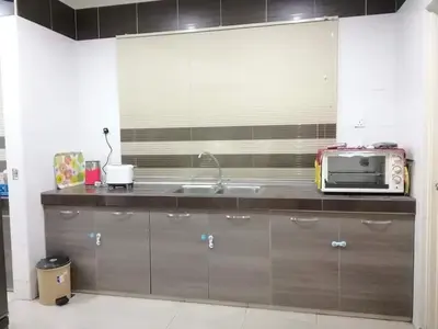 a kitchen with a sink and a microwave at Casa Margosa Homestay in Ipoh