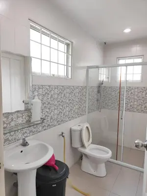 a bathroom with a toilet and a sink and a shower at Casa Margosa Homestay in Ipoh