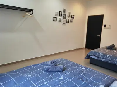 a bedroom with a blue teddy bear laying on a bed at Padang Serai Cozy Roomstay Share Bathroom in Padang Serai